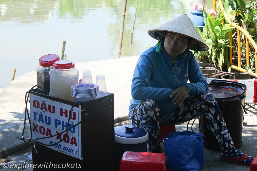 A local woman cooling off in a conical hat