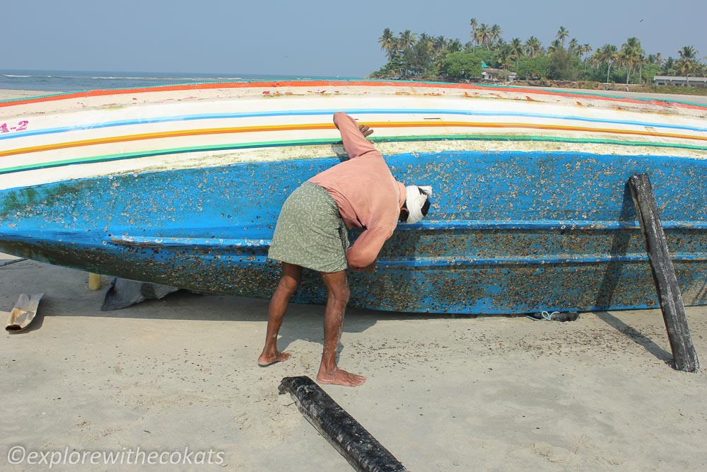 A fisherman cleaning his boat